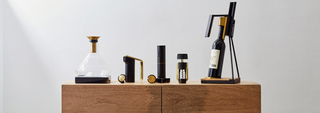 RBT by Rabbit. Wine Decanter, Lever wine opener, electric wine opener, wing corkscrew, and tabletop corkscrew on top off a table
