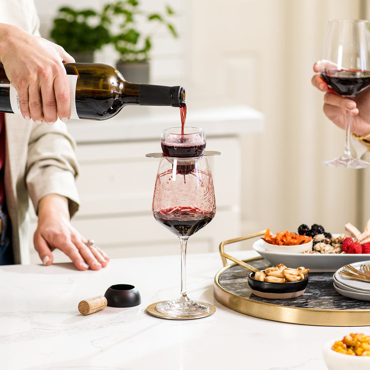 Wine pouring through wine aerator to