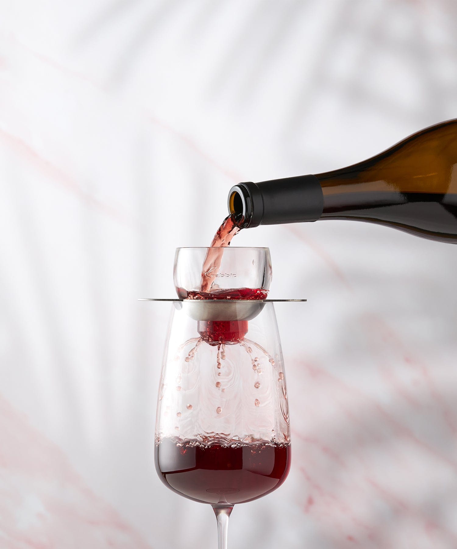 Rabbit Wine Aerator in use, with red wine elegantly flowing through it and into a glass, enhancing its flavor and aroma.